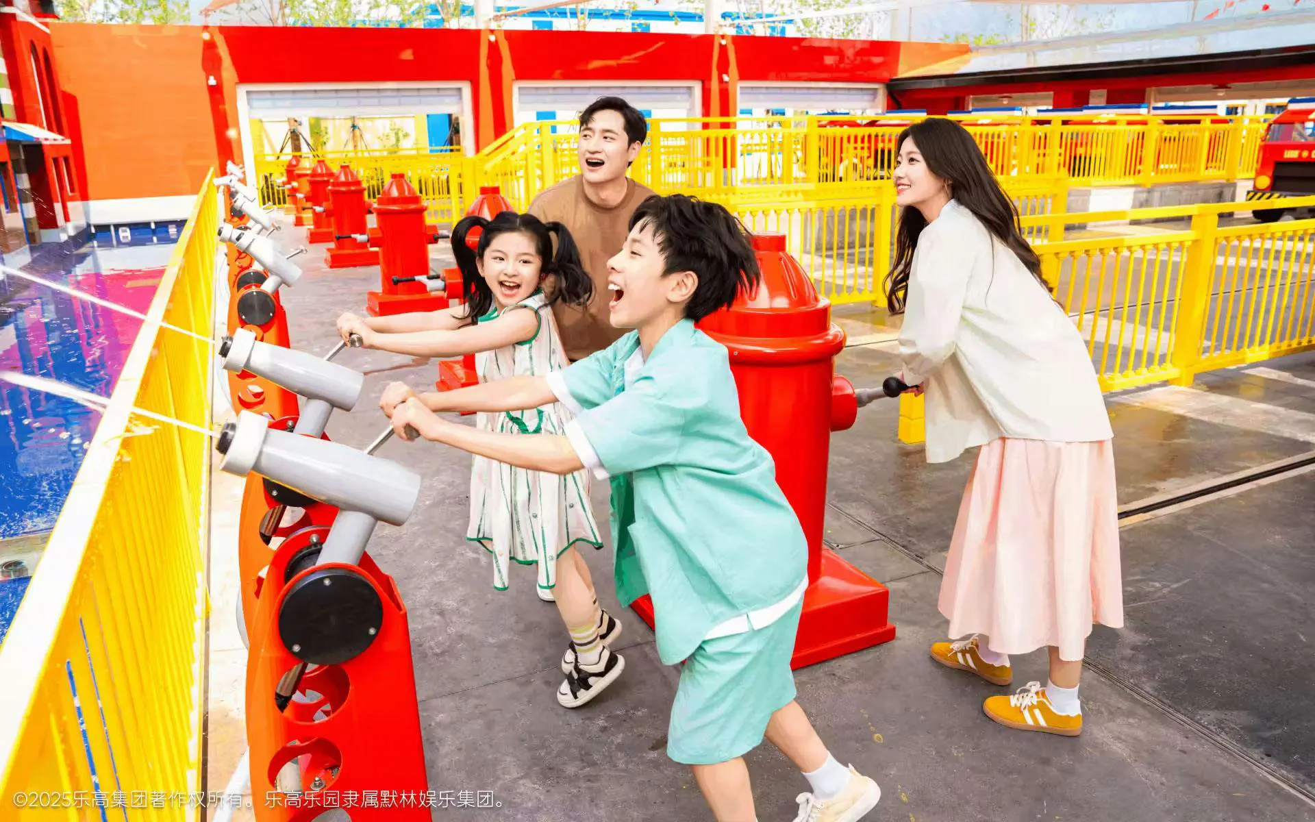 Family enjoying water-shooting ride at Legoland resort's Fire Academy.