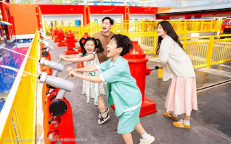 Family enjoying water-shooting ride at Legoland resort's Fire Academy.
