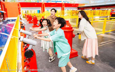 Family enjoying water-shooting ride at Legoland resort's Fire Academy.
