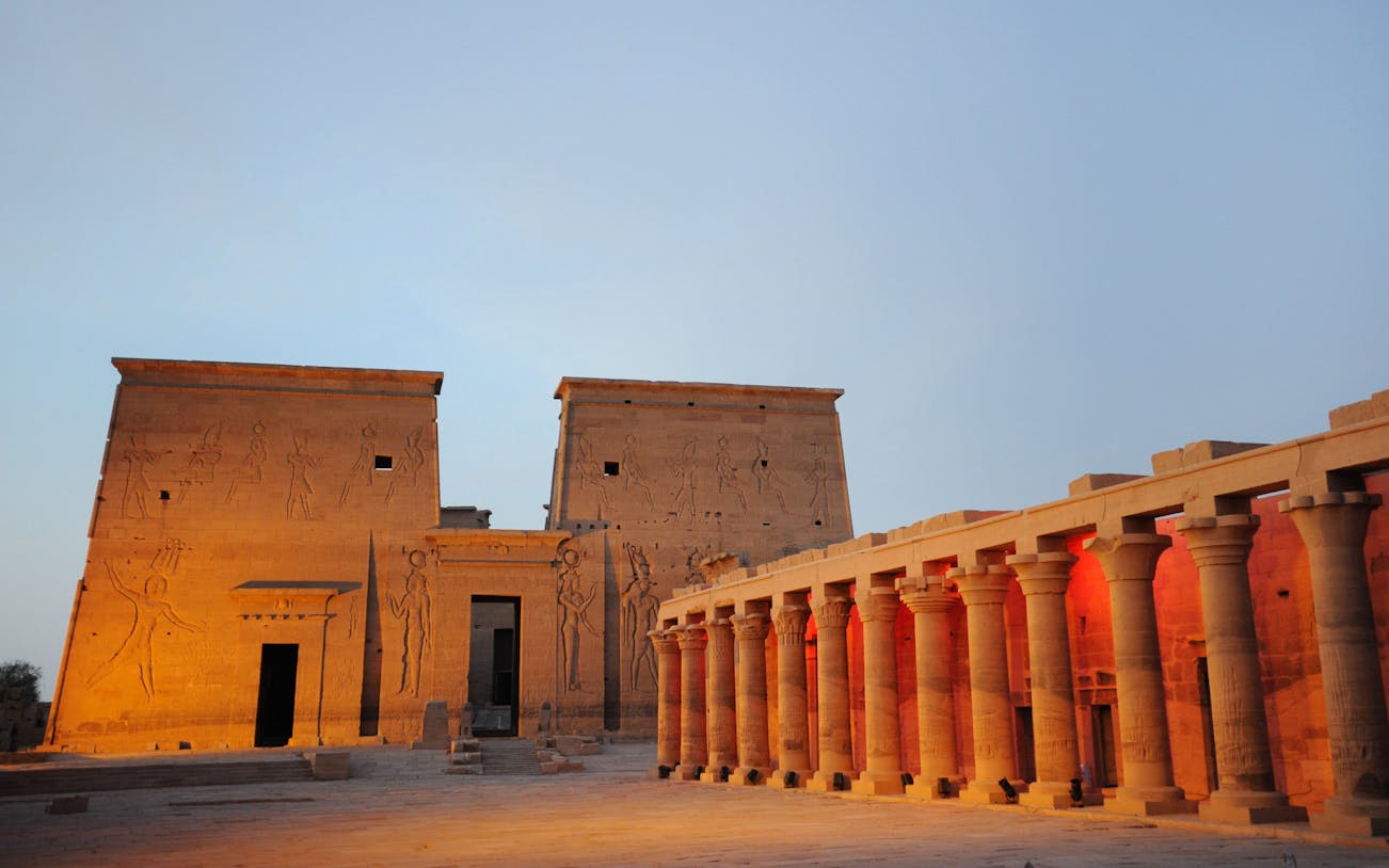 Temple of Philae illuminated during light show, Aswan, with hieroglyphics and columns.