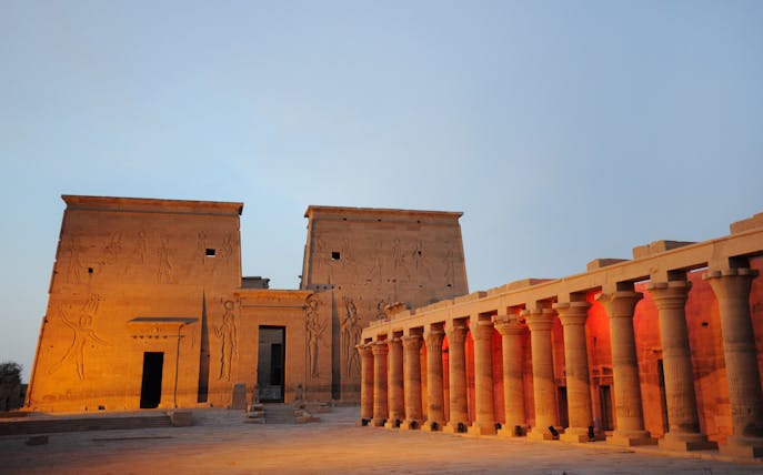 Temple of Philae illuminated during light show, Aswan, with hieroglyphics and columns.