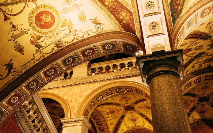 Ornate ceiling and column inside the Hungarian State Opera House, Budapest.