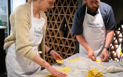 Participants making pasta at a Milan cooking class.
