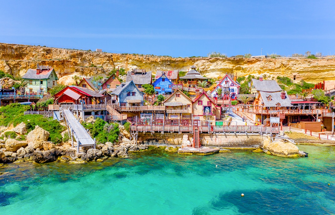 Aerial view of Popeye Village, colorful seaside village in Malta.