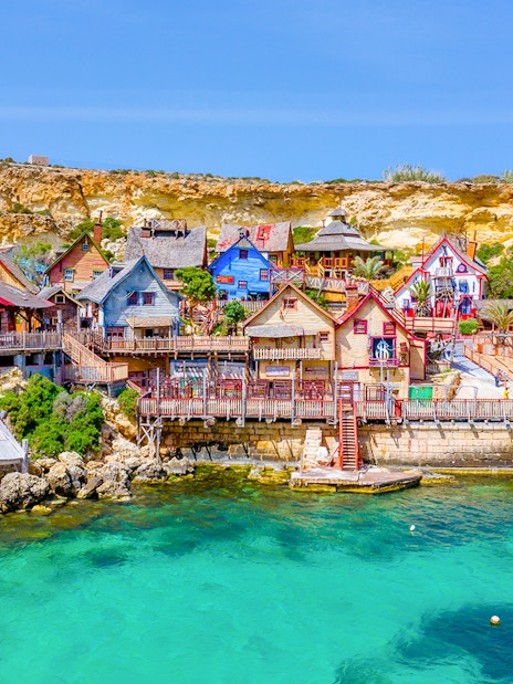Aerial view of colorful wooden buildings at Popeye Village, Malta.