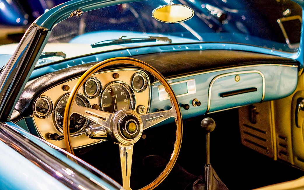 Classic car dashboard and steering wheel at Malta Classic Car Collection Museum.