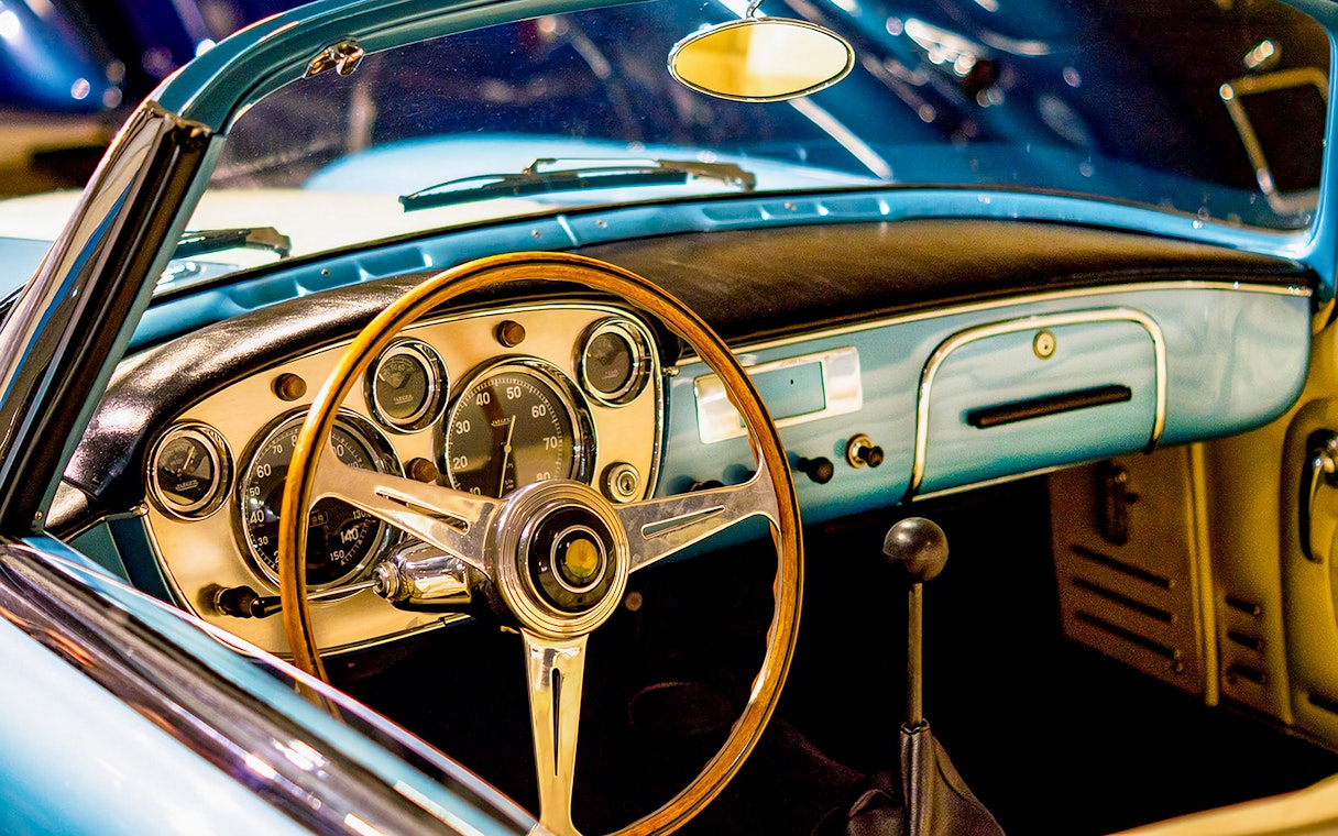 Classic car dashboard and steering wheel at Malta Classic Car Collection Museum.