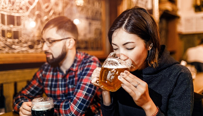 Prague beer tour group enjoying local brews at historic pub.