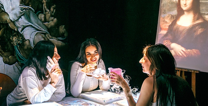 Patrons enjoying a dinner course at Seven Paintings Dineamation Experience