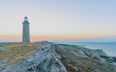 Absheron lighthouse on rocky seashore at sunset near Baku, Azerbaijan.