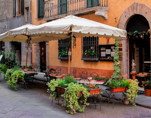 Cafe terrace with tables and chairs near Castel Sant’Angelo, Rome.