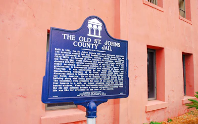 Old St. Johns County Jail sign in St. Augustine, highlighting historical significance.