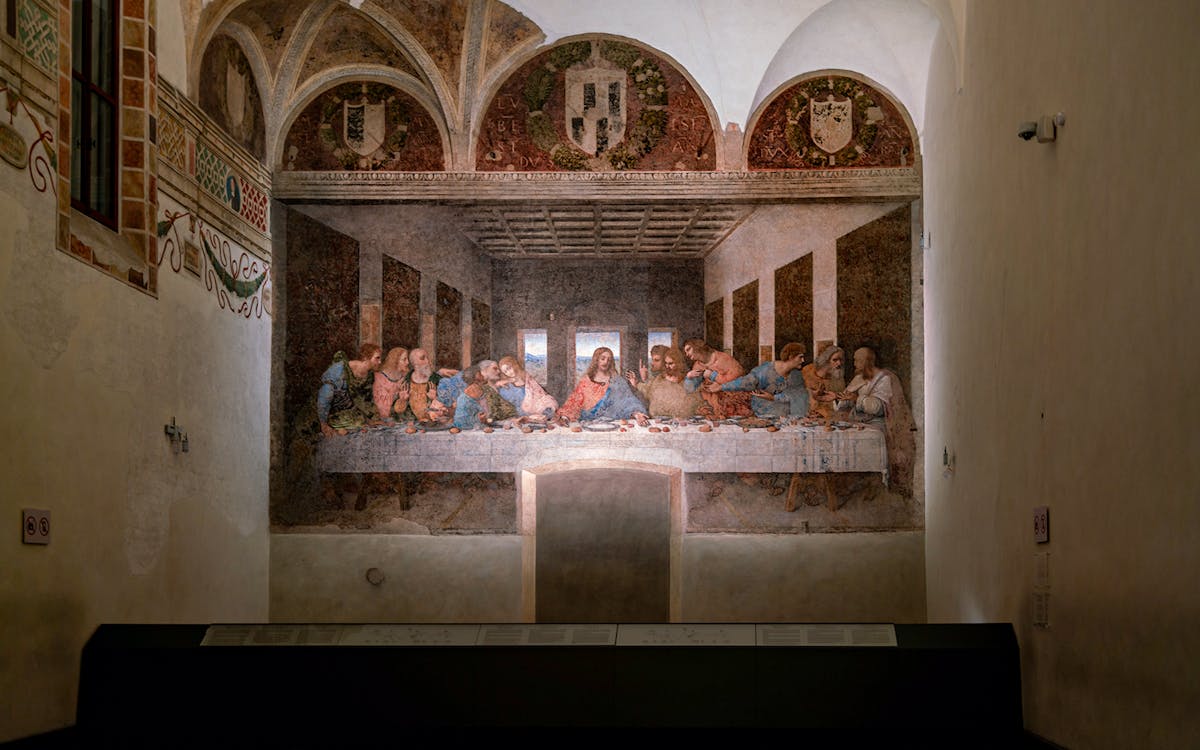 Visitors viewing Da Vinci's Last Supper fresco in Milan's Santa Maria delle Grazie.