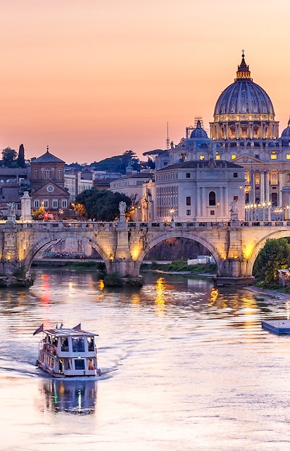 Cruise on the Tiber River with St. Peter's Basilica in Rome at sunset.