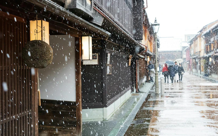 Snowfall on traditional street in Shirakawa-go during day tour from Kanazawa.
