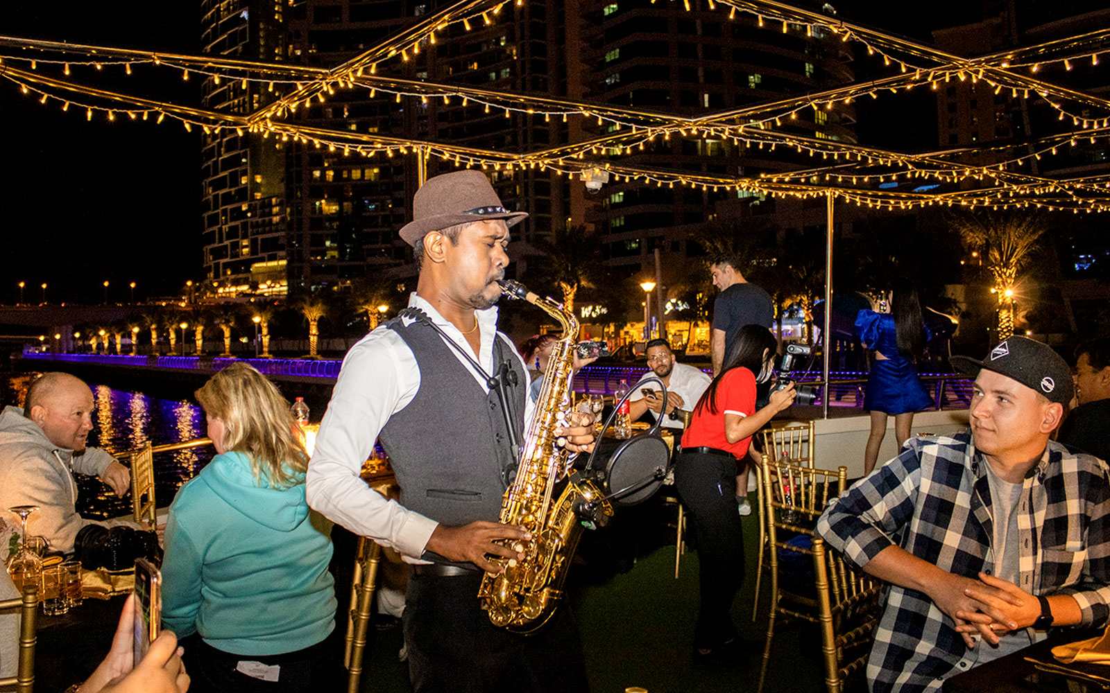 Saxophonist performing on a Dubai Marina sunset cruise with buffet dinner.