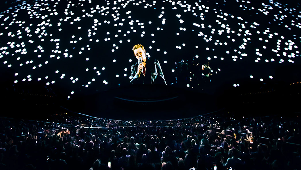 Concert at Sphere Las Vegas with singer performing under starry lights.