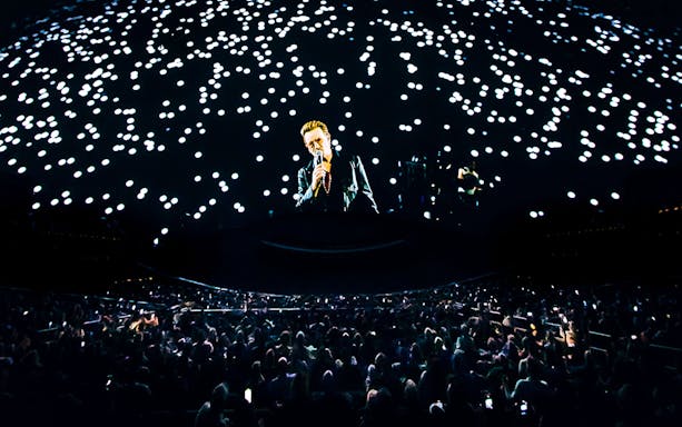 Concert at Sphere Las Vegas with singer performing under starry lights.