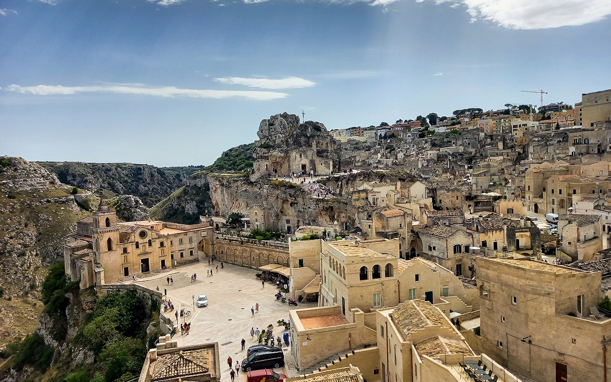 Matera's ancient stone cityscape with Casa Grotta and surrounding cliffs.