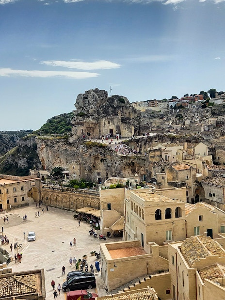 Matera's ancient stone cityscape with Casa Grotta and surrounding cliffs.