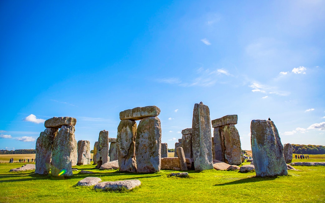Stonehenge under a clear blue sky in Wiltshire, England.