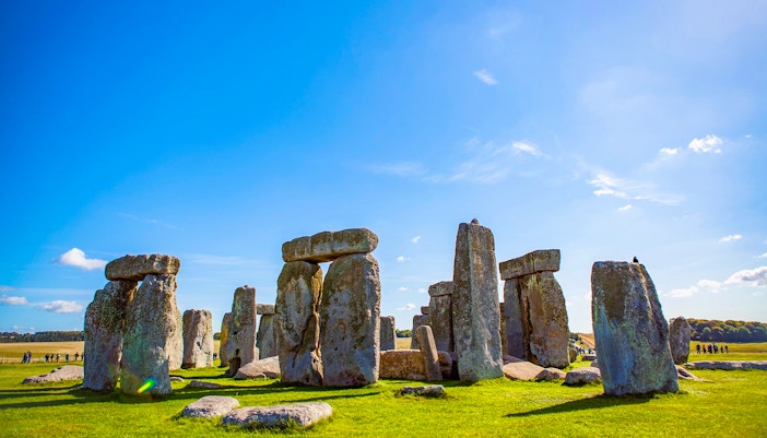 Stonehenge under a clear blue sky in Wiltshire, England.