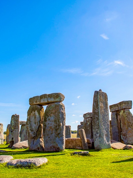 Stonehenge under a clear blue sky in Wiltshire, England.