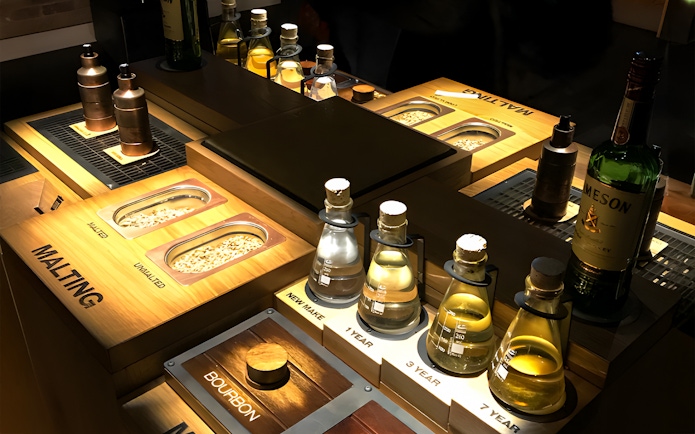 Jameson Whiskey Distillery display with malting grains and aging samples.