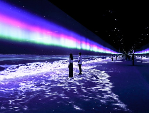 Visitors exploring immersive light display at ARTE Museum Dubai.
