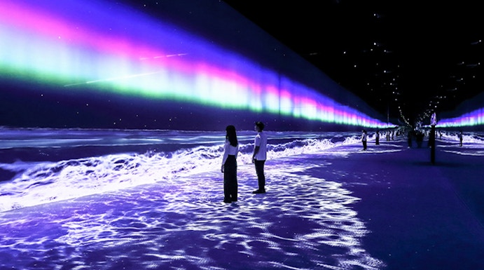 Visitors exploring immersive light display at ARTE Museum Dubai.