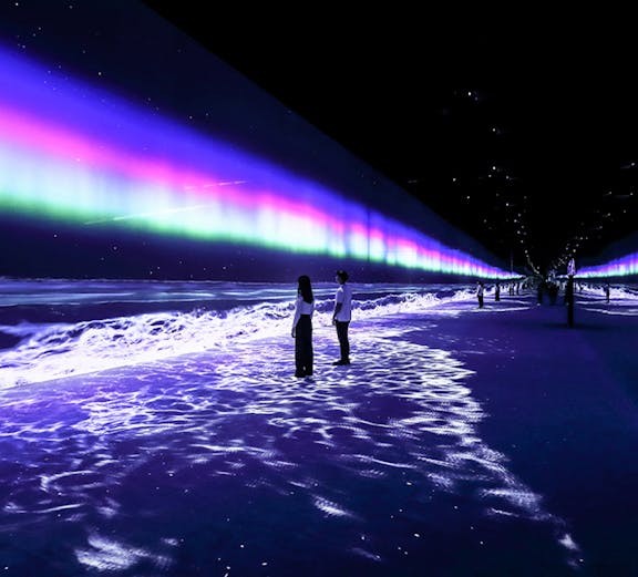 Visitors exploring immersive light display at ARTE Museum Dubai.