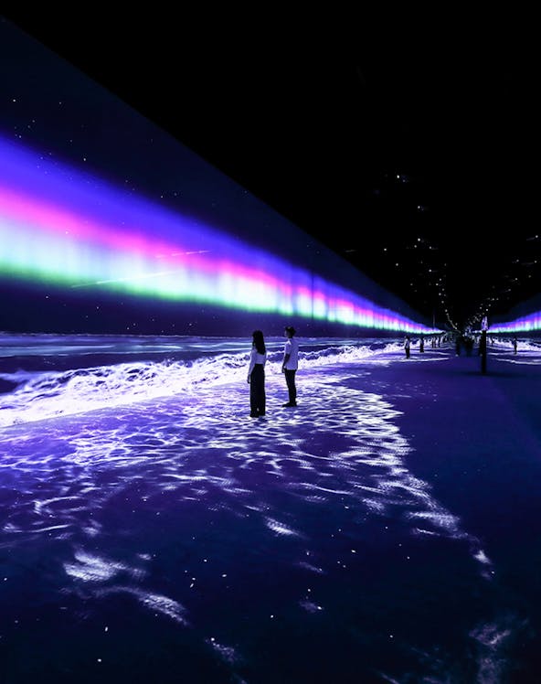 Visitors exploring immersive light display at ARTE Museum Dubai.