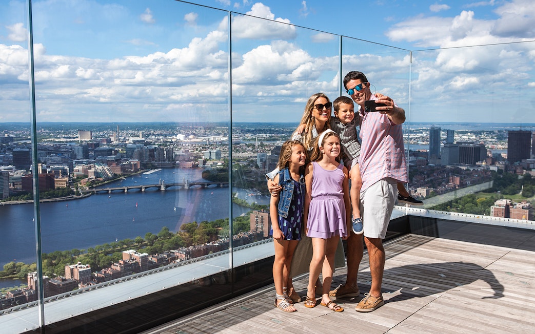 Family enjoying the skyline view from View Boston observation deck.