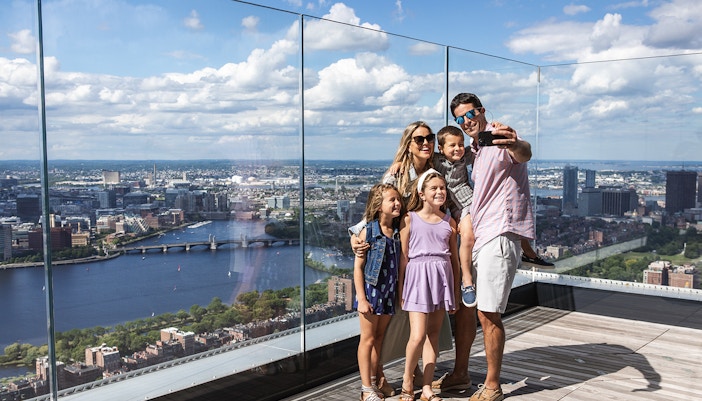 Family enjoying the skyline view from View Boston observation deck.