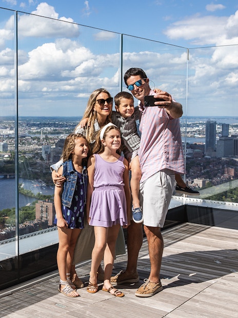 Family enjoying the skyline view from View Boston observation deck.