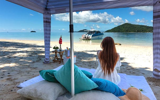 Luxury private charter setup on Phuket beach with view of Phi Phi Islands boat.