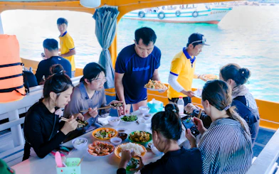 Guests enjoying lunch on a boat during the 3 Island Hopping Tour in Phu Quoc.