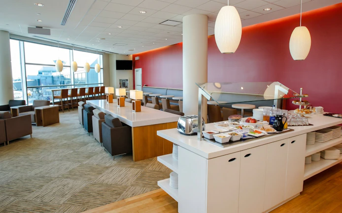 Plaza Premium Lounge seating and buffet area at Terminal 3, Toronto Pearson Airport.