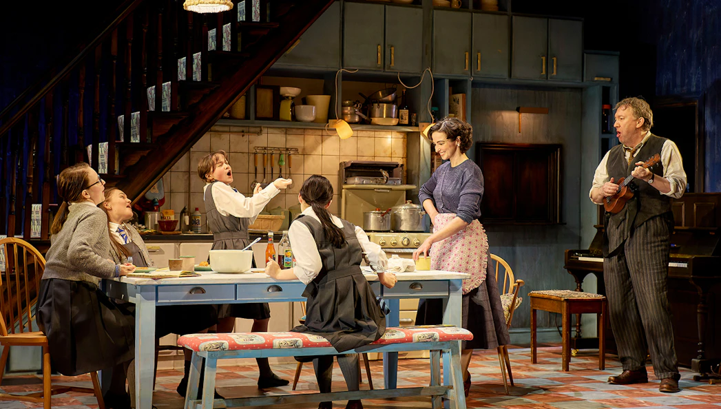 Family gathered in a cozy kitchen, enjoying a meal and music, reminiscent of The Hills of California.