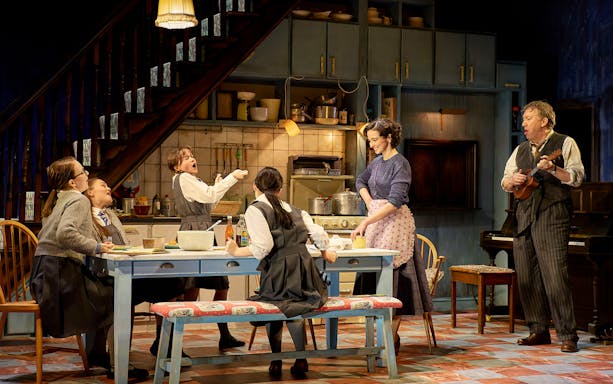 Family gathered in a cozy kitchen, enjoying a meal and music, reminiscent of The Hills of California.
