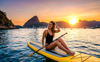 Stand-up paddleboarding at sunrise near Sugarloaf Mountain, Rio de Janeiro.