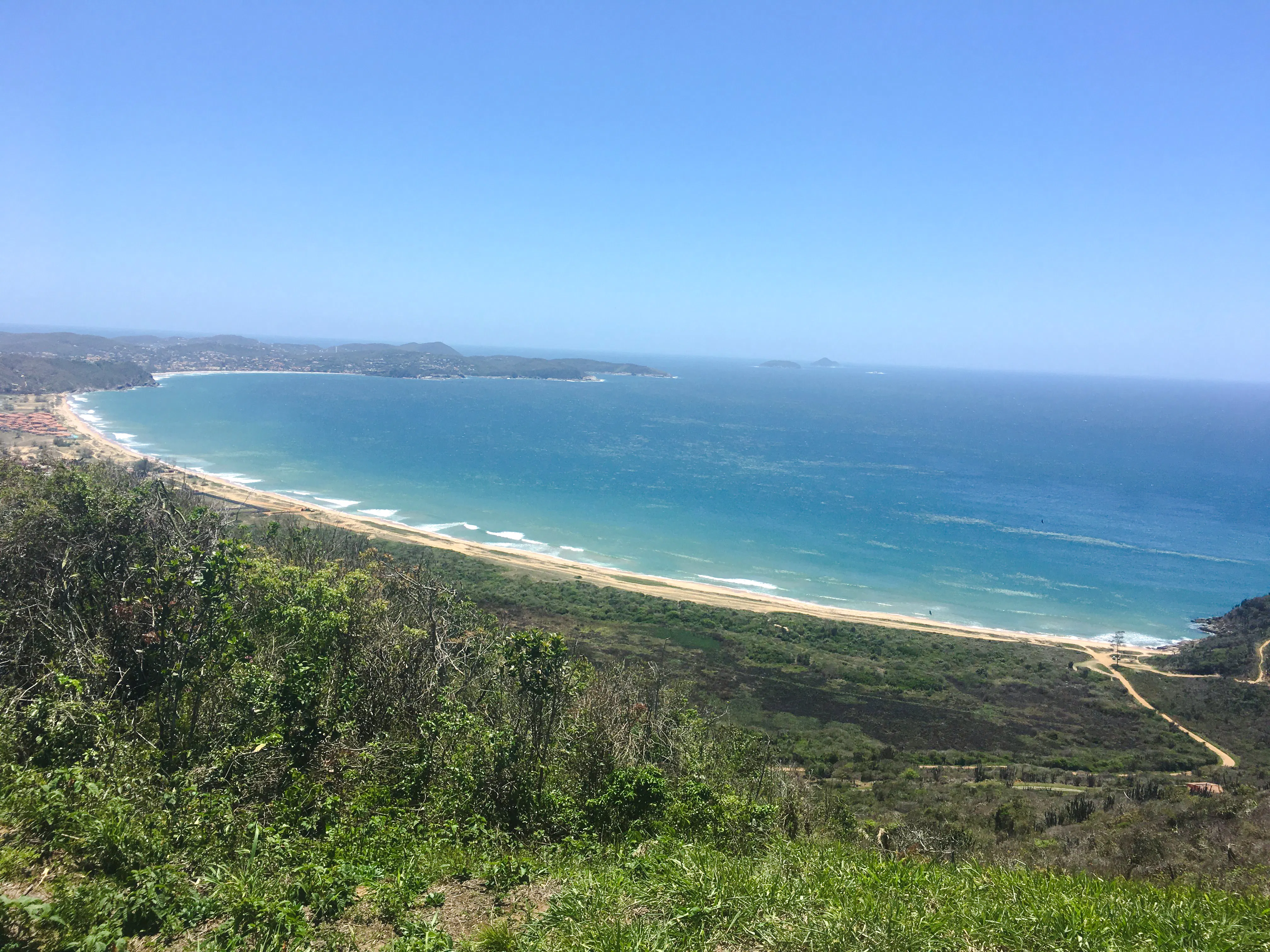 Coastal view of Emerências and José Gonçalves, Rio de Janeiro, with lush greenery and ocean.