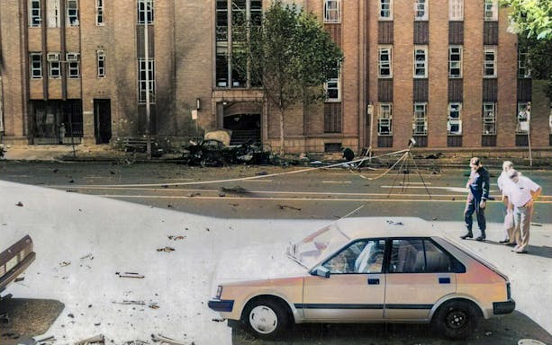 Street scene of a historic crime site in Melbourne with damaged building and debris.