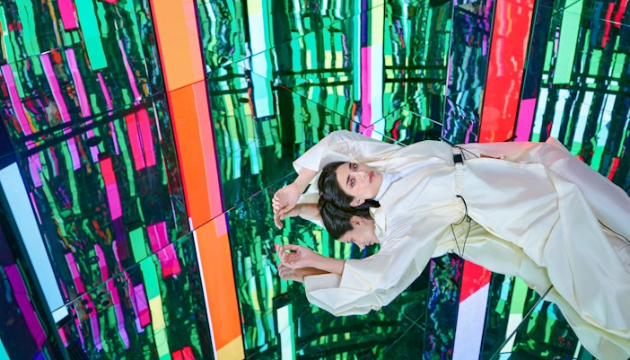 Woman floating on top of an infinite energy vortex surrounded by bubbling energy, AYA universe