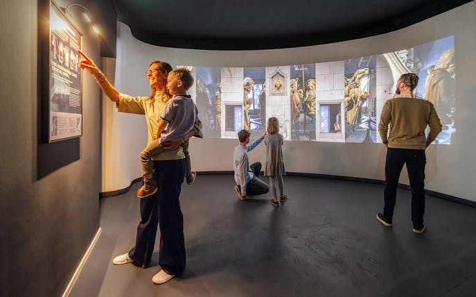 Guests exploring exhibits inside Praga Magica Interactive Exhibition.