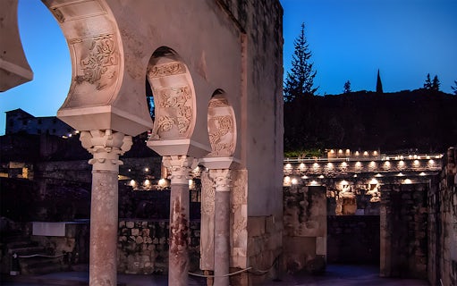 Arched columns illuminated at night in Medina Azahara, Córdoba.