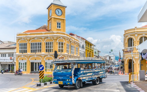 Phuket Old Town with blue local bus and Sino-Portuguese architecture on a guided tour.