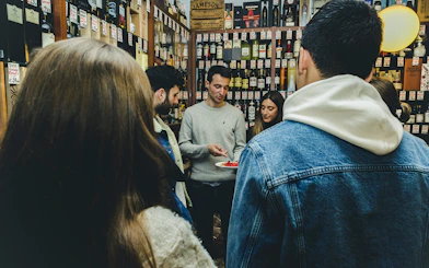 Group tasting wine and food in a Porto shop during a tour.