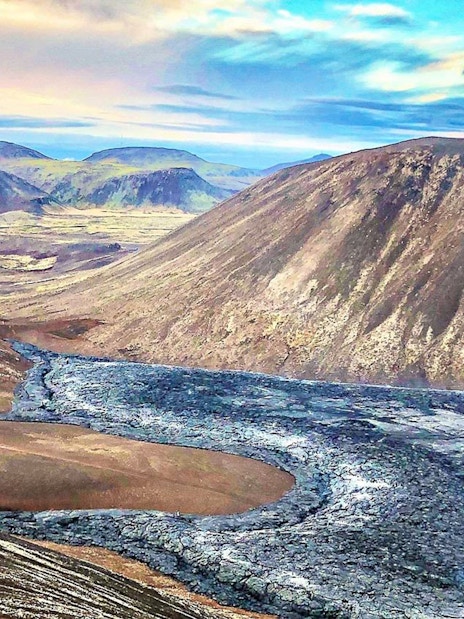 Volcanic landscape in Reykjanes, Iceland, with lava fields and distant hills.