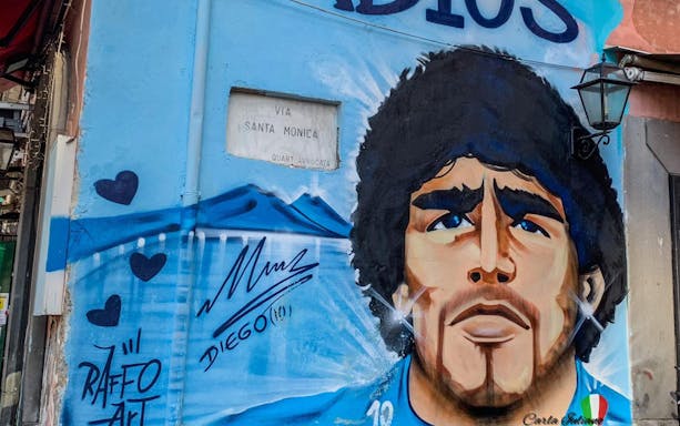 Mural of Maradona on Via Santa Monica in Naples, Italy, part of a guided tour from Rome.